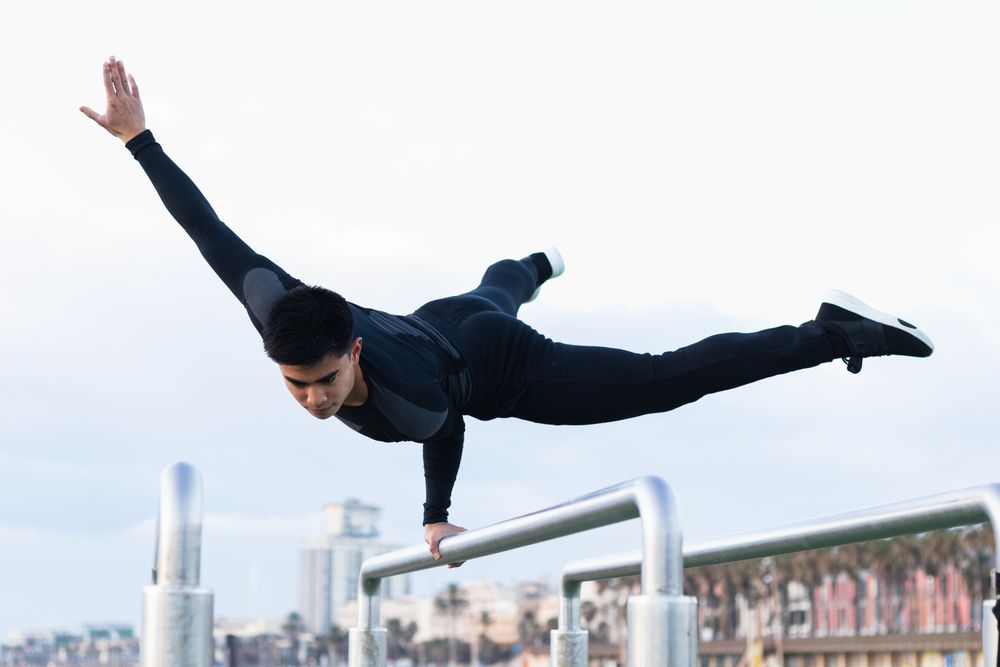Athlete doing exercise on parallel bars