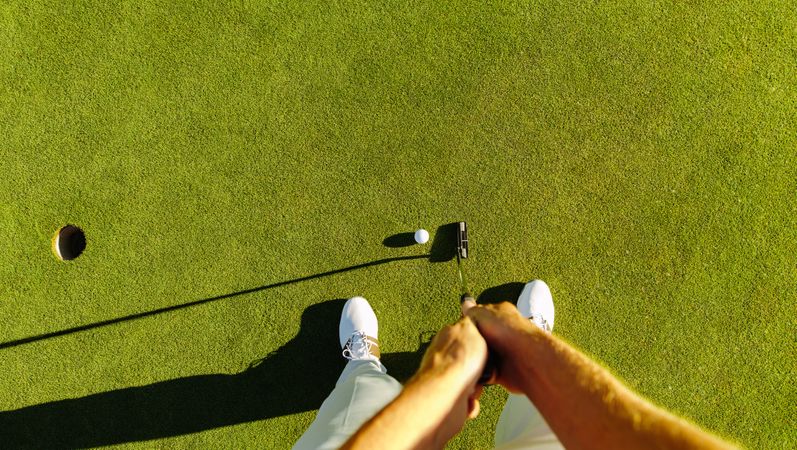 Perspective of professional golfer playing golf on field