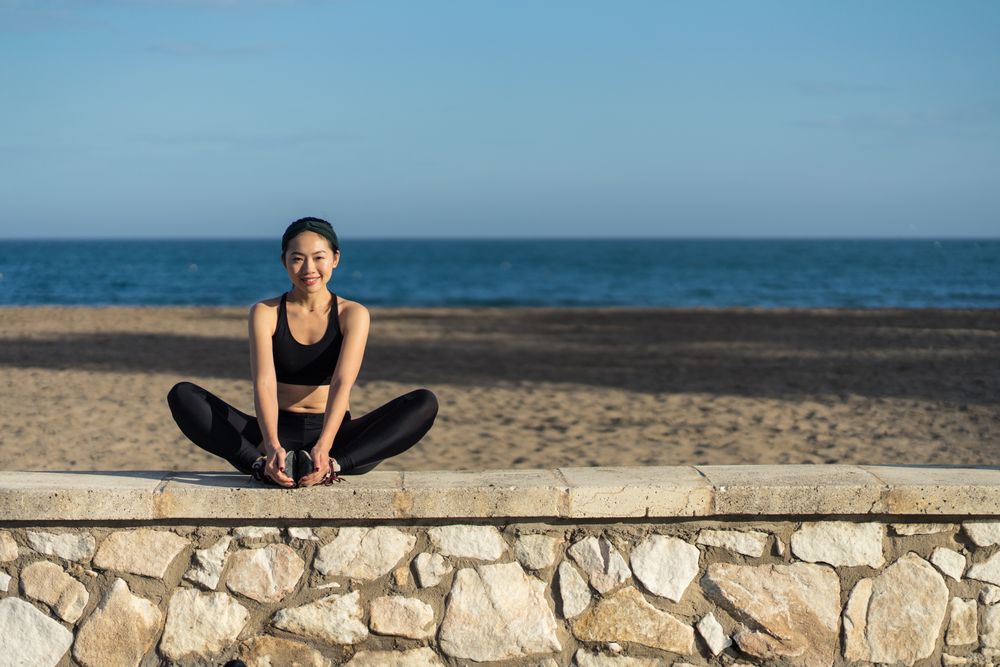 Woman stretching at seaside