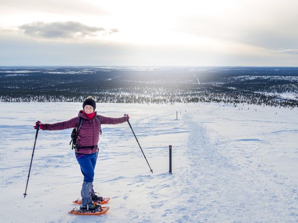 Happy woman snowshoeing on wintry day