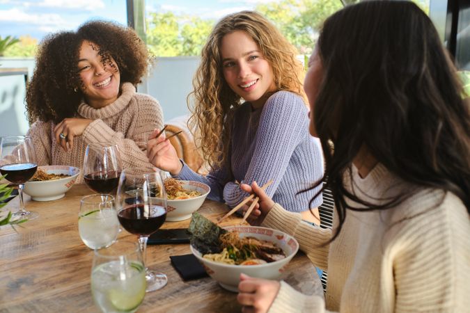Glad diverse ladies having lunch in restaurant