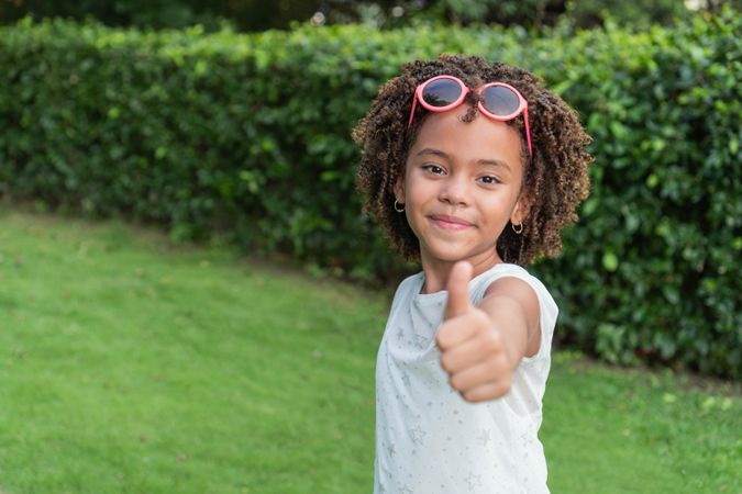 Girl with afro standing in the park