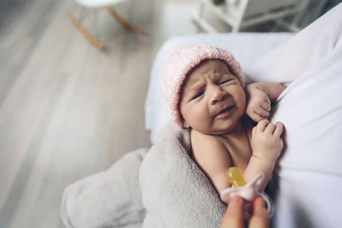 Baby girl crying because wants pacifier