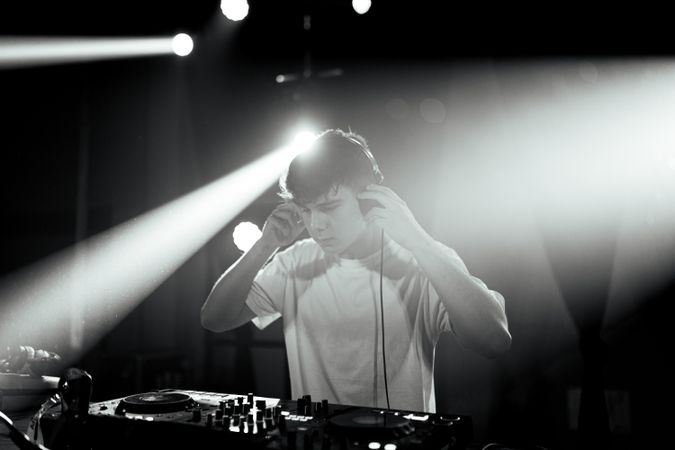 Unsaturated photo of a disc jockey at turntables