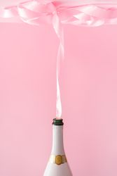 Champagne bottle with pink party ribbon