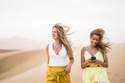 Happy women walking in the desert in desert