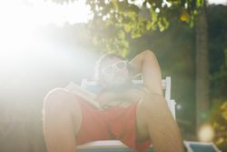 Man chilling on deckchair in sunshine