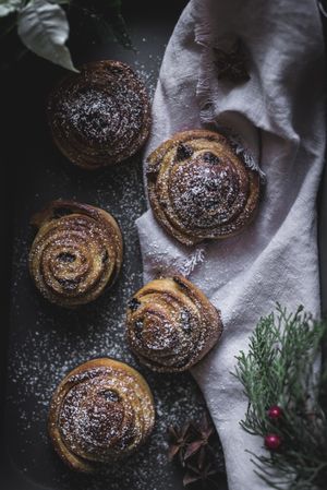 Herbs and napkin near cinnamon rolls