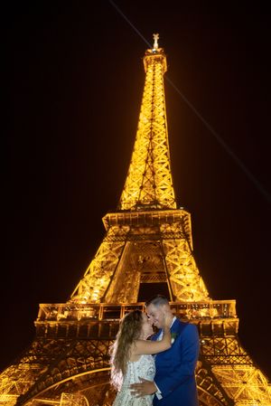 Overjoyed bridal pair enjoying in each other while kissing