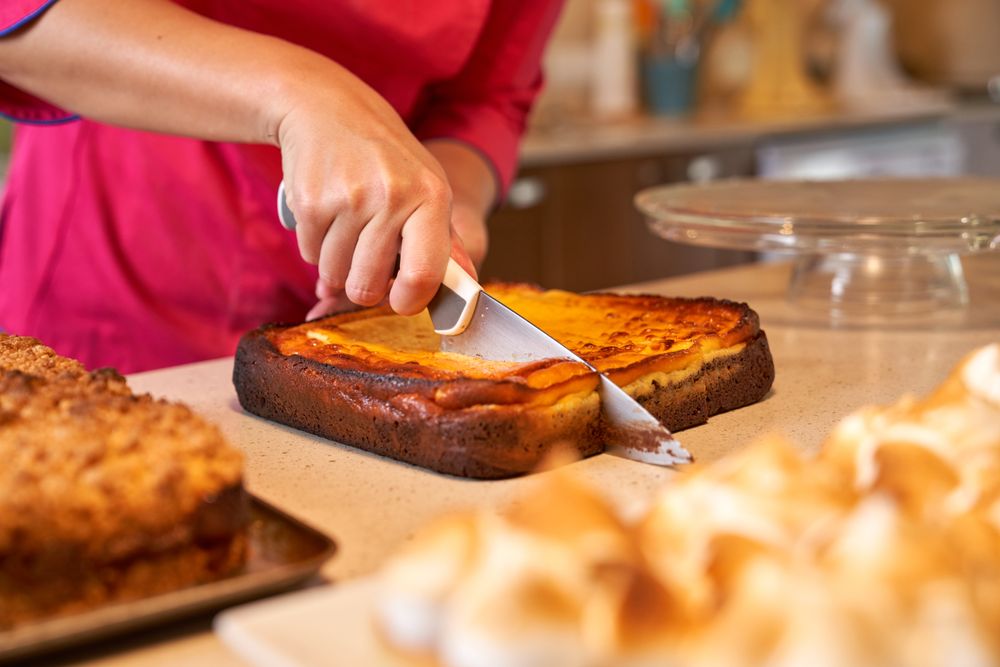 Crop person cutting freshly baked pie