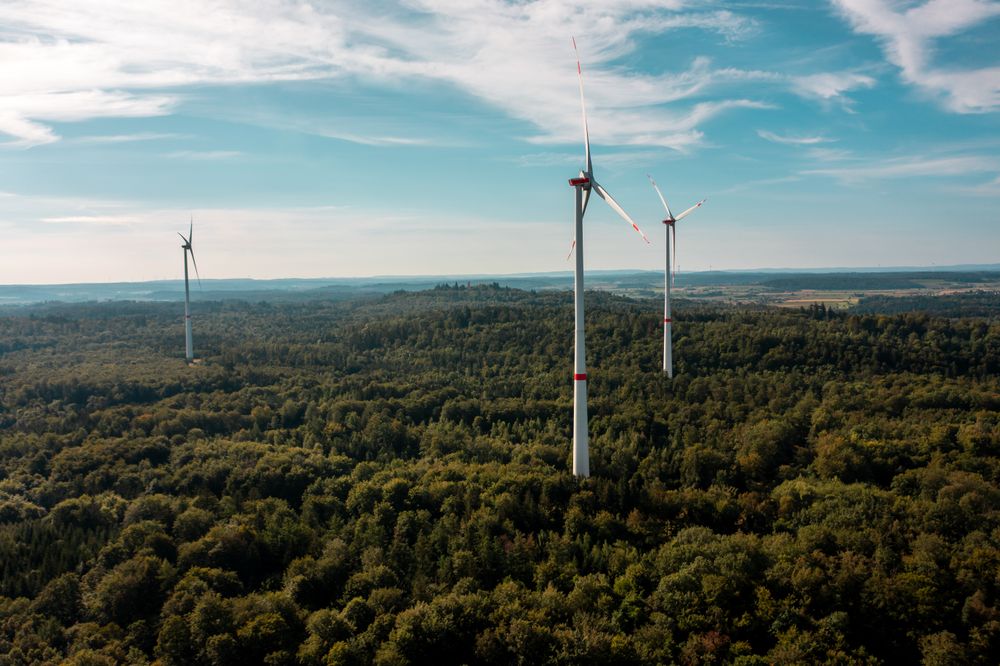 Aerial view image with vast forest and wind turbines, in Baden Wurttemberg region, Germany