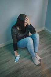 Woman holding mobile desperate for social networks problems