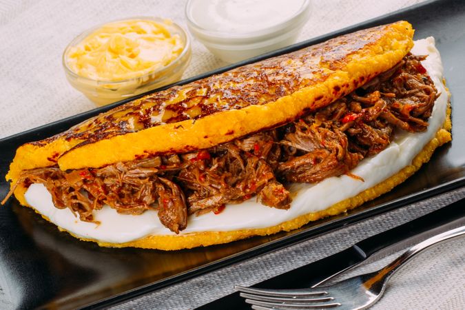 Cachapa, typical Venezuelan dish made with corn and stuffed with cheese and grilled meat