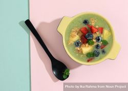 Top view of smoothie with fresh fruit and granola on duo tone background 5oazzb