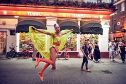 London, England, United Kingdom - July 7th, 2019: Man leaping in air with yellow cape
