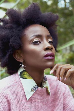 Portrait of Black woman in pink sweater