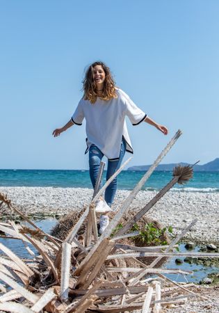 Young woman walking near dried plants
