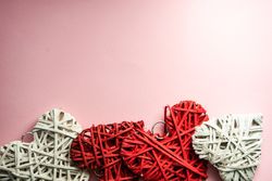 Pink pastel table with thatched red heart ornaments