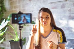 Woman recording a video of herself on her phone