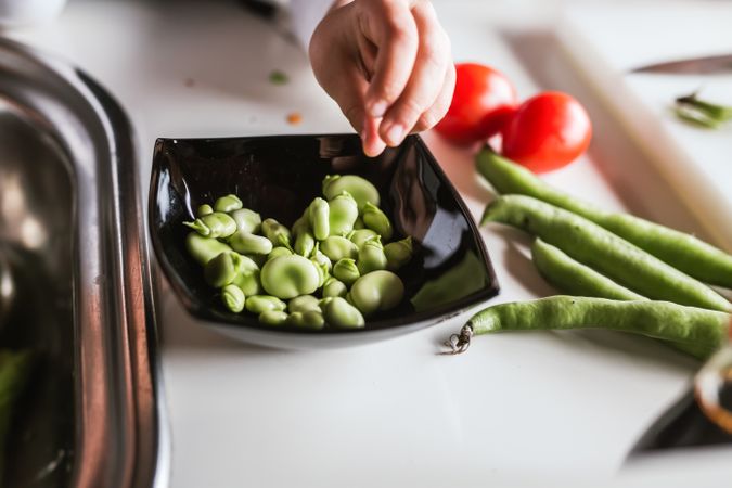 Anonymous young girl preparing vegetables for salad