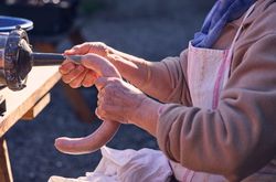 Anonymous elderly woman making sausage