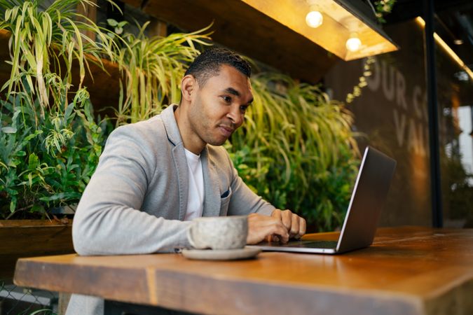 Man working on laptop at cafeteria
