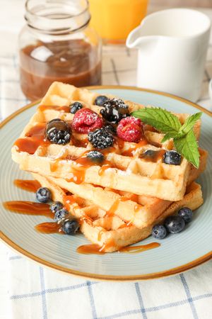 Composition of breakfast with belgian waffles, space for text
