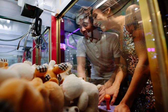 Happy couple playing games at a gaming arcade