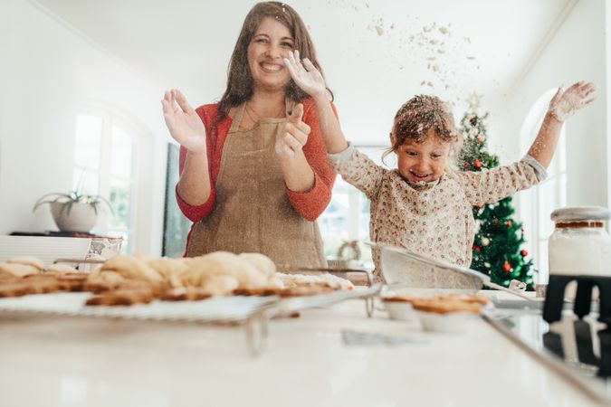 Mother and daughter playing while making Christmas cookies