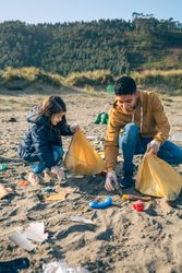 Young volunteers cleaning the beach
