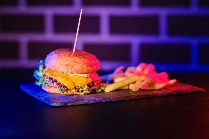 Delicious hamburger and fried potato on board