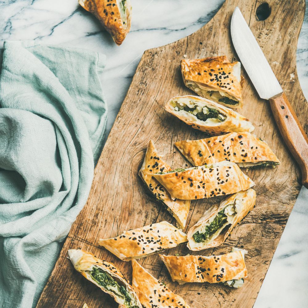 Turkish pastry, borek, sliced on wooden board