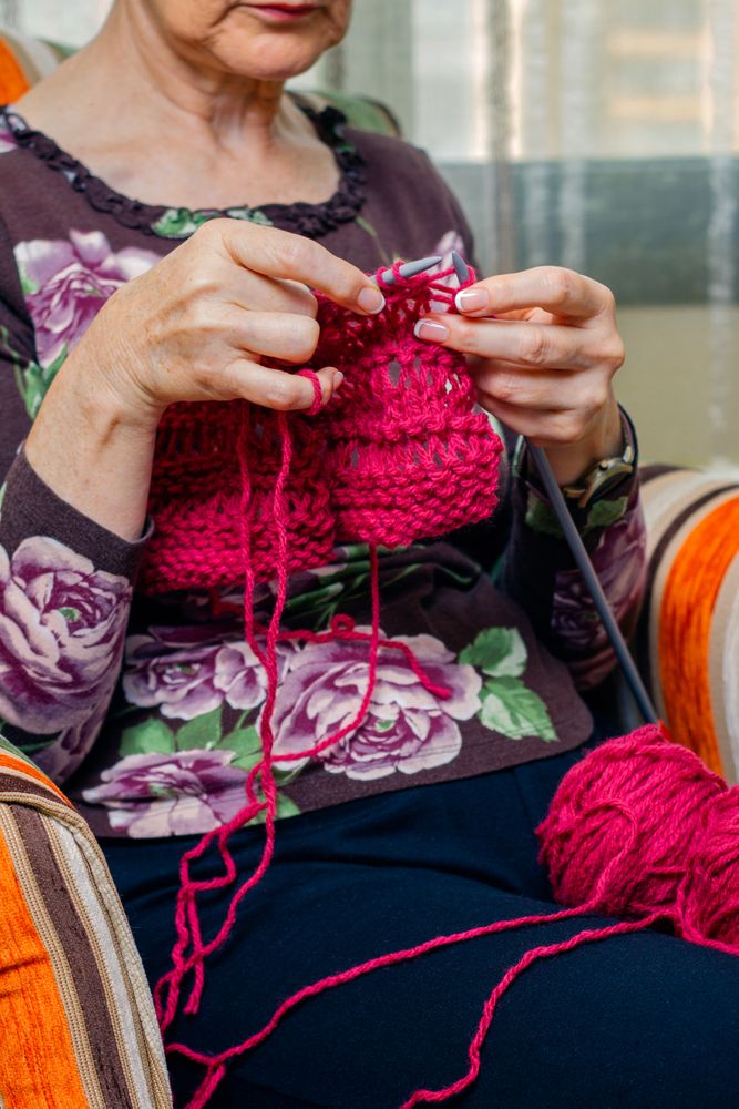Hands of woman knitting a wool sweater