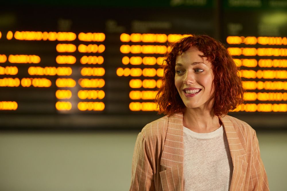 Smiling young female at railway station