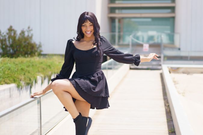 Woman smiling while dancing in an urban space