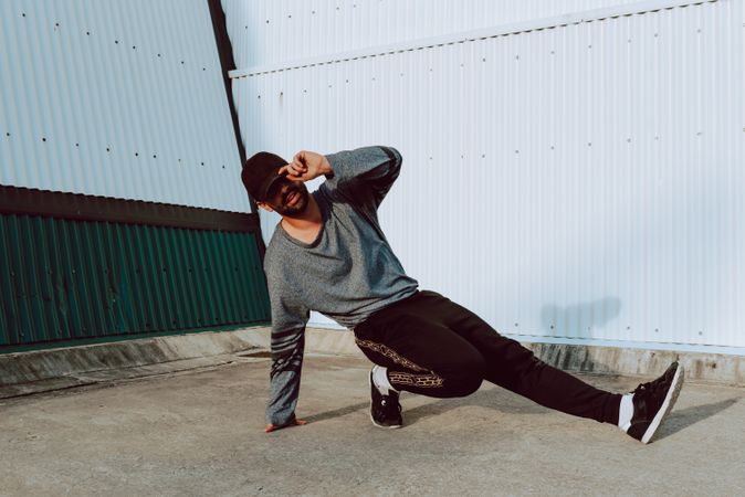 Man performing handstand near wall