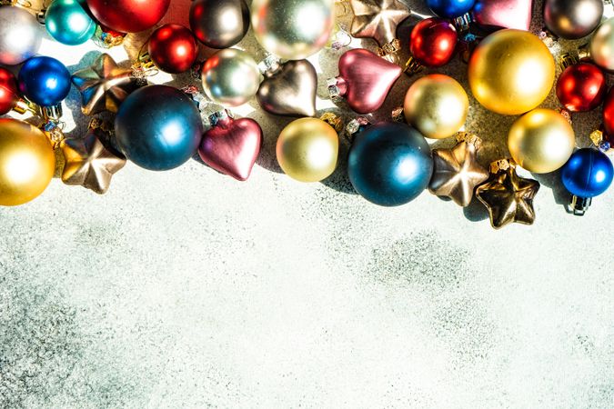 Christmas card concept of colorful baubles on concrete counter