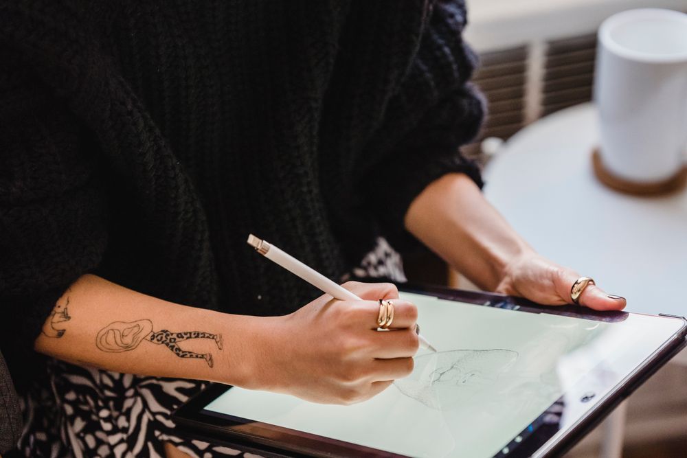 Cropped image of artist drawing on computer tablet