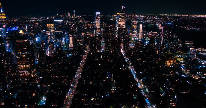 Aerial Helicopter View of Downtown Manhattan Architecture. Drone Photo of Skyscrapers and Office Buildings at Night. Evening Urban Landscape with Historic New York City