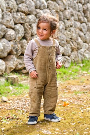 Cute little boy on rough land in summer