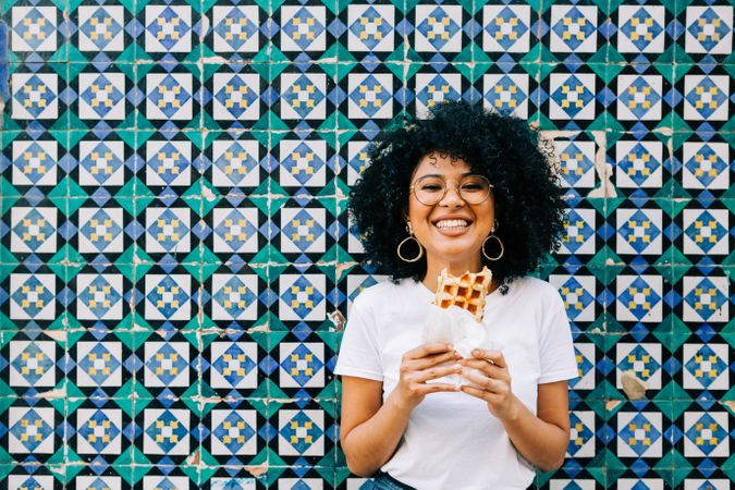 Cheerful Black female with tasty waffle