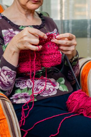 Hands of woman knitting a wool sweater