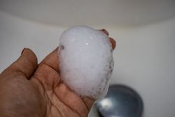 Hands with suds over sink