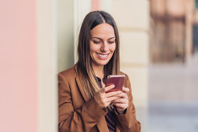 Pleased female in stylish outfit on street smiling away
