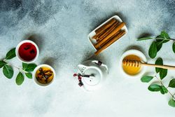 Top view of tea pot with cinnamon with honey