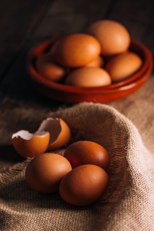 Chicken eggs on napkin on wooden table