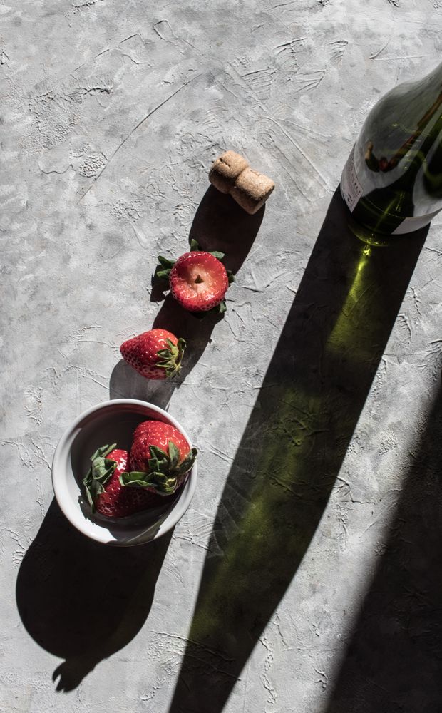 Strawberries near bottle of drink