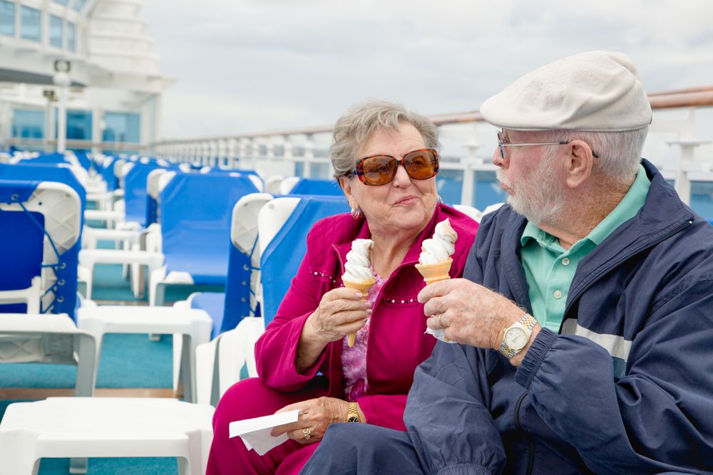 Adult Couple Enjoying Ice Cream On The Deck of a Luxury Passenger Cruise Ship.