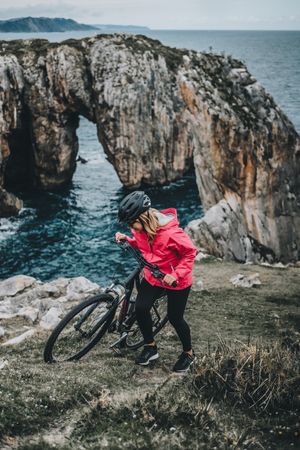 Female bicyclist on rocks