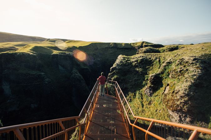 Man on ledge over cliffs